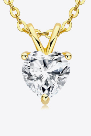Gold solitaire necklace with heart-cut moissanite pendant and 18K gold-plated chain.