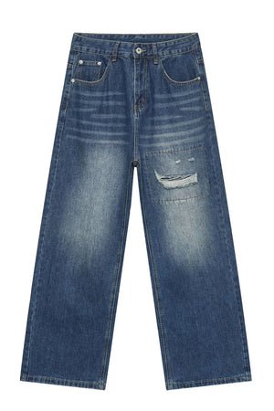 Baggy denim jeans in medium wash with patchwork and distressed details.