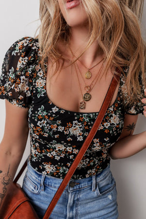 Black floral puff sleeve bodysuit with a square neckline.