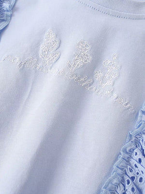 Light blue cotton t-shirt with embroidered floral detail and ruffled eyelet trim.