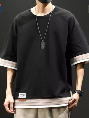 Black cotton blend t-shirt with contrast stitching on sleeves and hem, loose fit.
