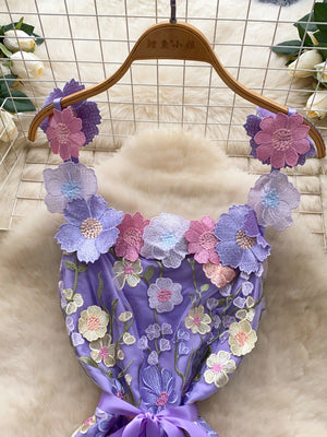 Purple mini dress with embroidered floral details and a bow accent.