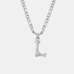 Textured initial pendant necklace with a silver chain and 'L' charm.