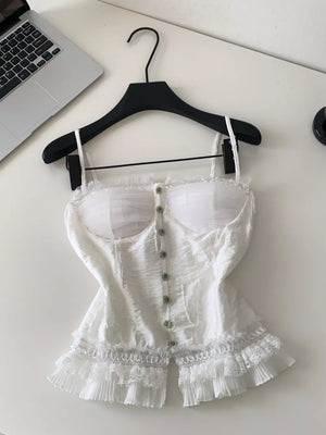 White lace ruffle hem tank top with button front and sheer bust detail.