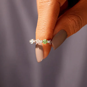 Silver enamel floral cluster ring with clear and green accents.