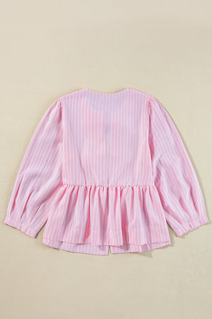 Blush pink striped peplum blouse with long puff sleeves and a ruffled hem.