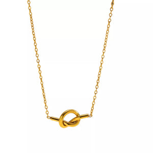 Gold-plated knot pendant necklace with delicate chain.