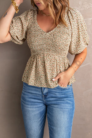 Floral smocked bodice peplum top with puff sleeves and V-neck