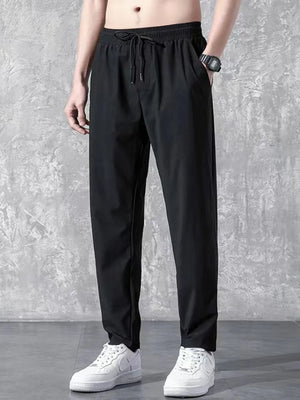 Black relaxed-fit drawstring trousers with elastic waistband and side pockets.