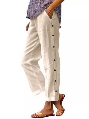 Apricot relaxed fit pants with decorative side buttons and pockets.