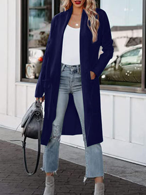 Dark blue open-front duster cardigan with pockets, styled with jeans and a white top.