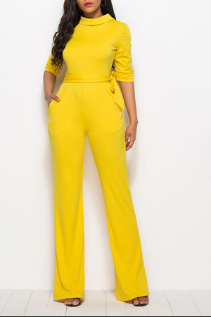 Yellow belted palazzo jumpsuit with high neckline and 3/4 sleeves.