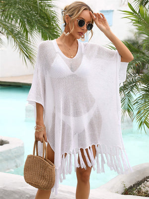 White open-knit fringe beach poncho with V-neck and short sleeves.