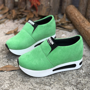 Green slip-on sneakers with a round toe and white platform sole.