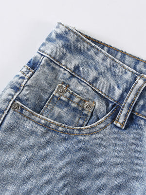 Light wash denim jeans with distressed details and shredded knee accents.