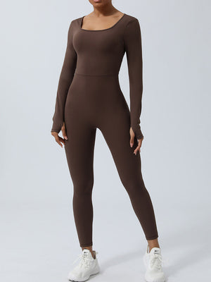 Chocolate long sleeve sculpting jumpsuit with square neckline and thumbholes, styled with white sneakers.