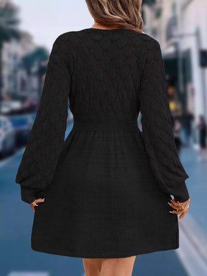 Black openwork knit V-neck sweater dress with cinched waist and above knee length.