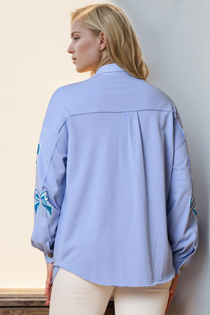 Light blue oversized shacket with embroidered bow details on sleeves.