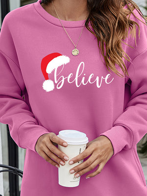 Dusty Pink Christmas graphic tunic sweatshirt with Santa hat and "believe" text.