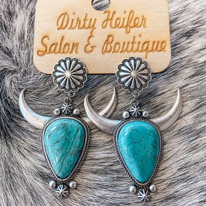 Southwestern crescent drop earrings with turquoise stones and silver bull horns.
