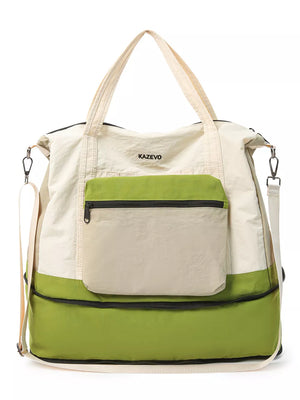 Chic nylon travel bag in cream and green with front zip pocket and adjustable straps.