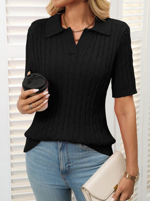 Black cable knit polo sweater with short sleeves and a collar.