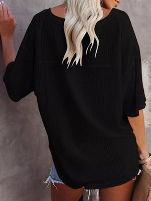 Black waffle knit relaxed v-neck t-shirt with short sleeves.