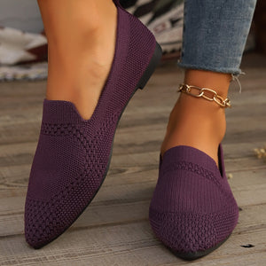 Purple pointed-toe knit flats with a breathable design and subtle textured pattern.