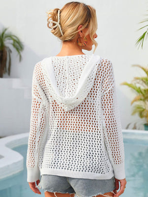 White crochet knit hoodie with a hood and long sleeves, showing a sheer back detail.