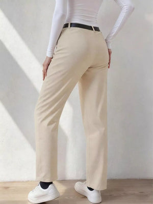 Beige wide-leg dress pants with pockets and belt loops, styled with a white top and black belt.
