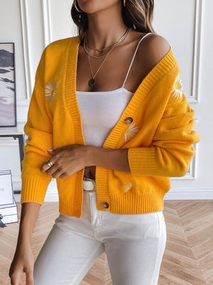 Gold button-down cardigan with embroidered daisies, ribbed cuffs and hem.