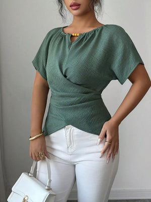 Green short sleeve maternity blouse with beaded keyhole neckline and wrap waist.