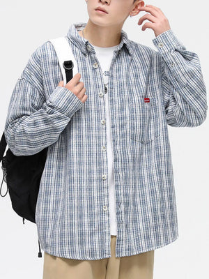 Men's light blue plaid button-up shirt with chest pocket