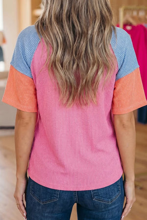 Ribbed t-shirt with color block sleeves in pink, orange, and blue.