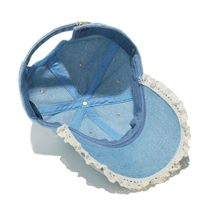 Light blue denim baseball cap with lace trim and adjustable strap.