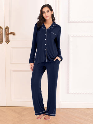 Navy pajama set with white piping and pockets. Long sleeve button-up top and pants.