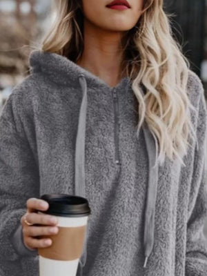 Gray cozy half-zip fleece hoodie with drawstring and hood.