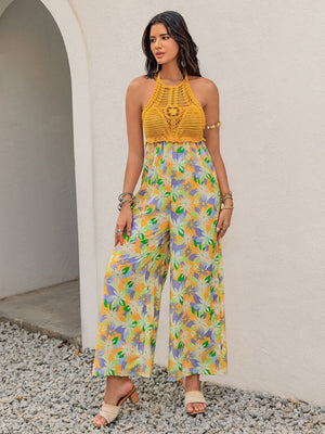 Gold crochet halter jumpsuit with a vibrant floral print and wide palazzo legs.