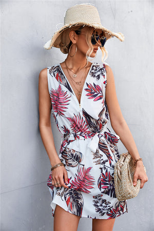 White floral zip-front tie-waist mini dress with red and green leaves.