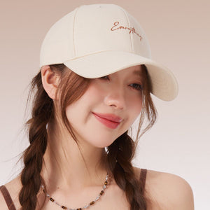 Rice white cotton baseball cap with cursive embroidery and curved brim.