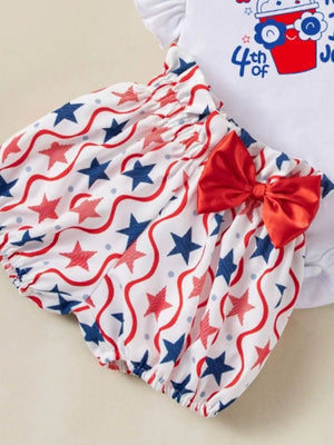 Baby outfit set with red, white, and blue star pattern bloomers and a red bow.