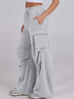 Light gray sweatpants with drape detail and cargo pockets, wide leg cut.