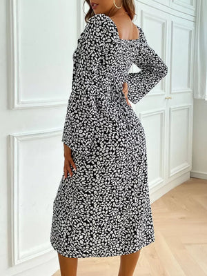 Floral print midi dress with flare sleeves and square neckline in black and white ditsy pattern.