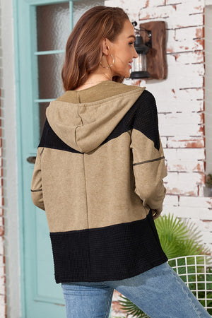 Colorblock knit zip-up hoodie in tan and black with waffle texture detail.