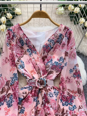Pink floral wrap mini dress with cinched waist and ruffle hem