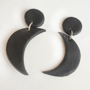 Halloween charm drop earrings in black with crescent moon charms and circular studs.