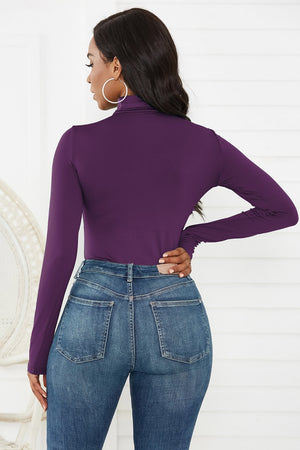 Deep Purple turtleneck thong bodysuit with long sleeves, styled with jeans.