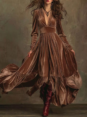 Dark brown velvet maxi dress with voluminous sleeves, deep V-neck, ruffled tiers, and flowing skirt.