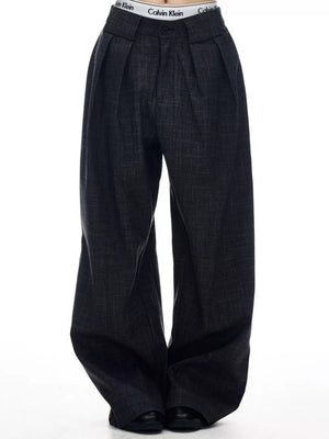 Men's dark grey wide-leg trousers with pleats and a textured weave.