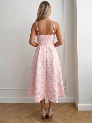 Blush pink textured floral a-line midi gown with spaghetti straps and a full skirt.